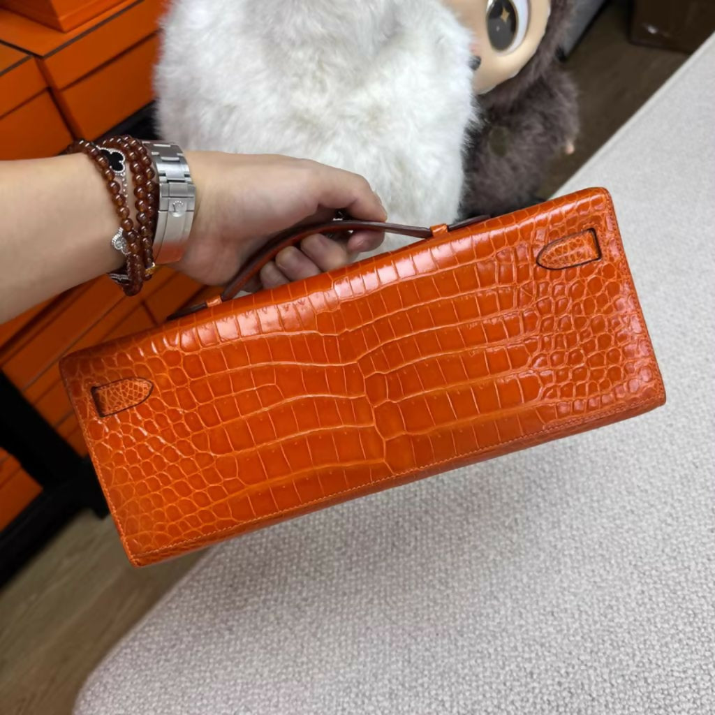 Hermès Kelly Cut Orange Shiny crocodile with Palladium Hardware