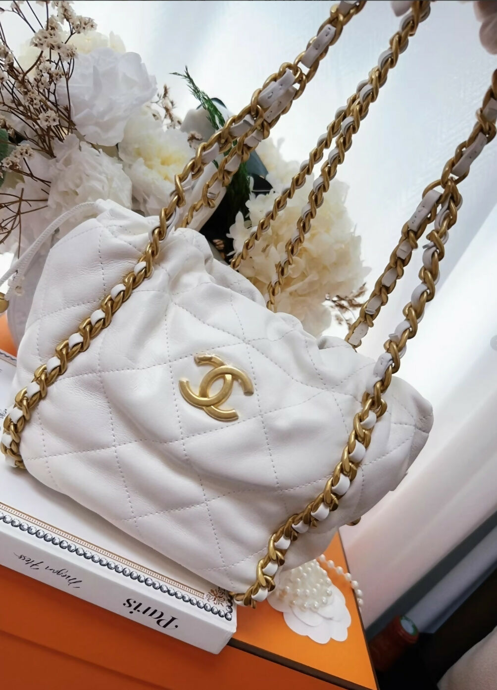 Chanel 22P ecru leather gold chain bucket bag